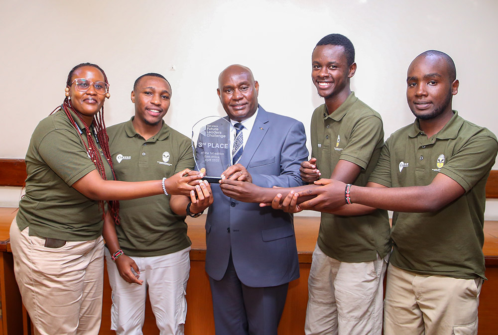 Tourism Tech\u2019 Project developers present the trophy they won during East Africa Future Leaders Challenge to the VC Prof. Benedict Mutua