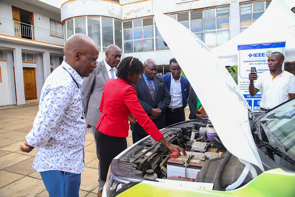 DVCs, Prof. Maurice Amutabi (Academic and Student Affairs) and  Prof. Isaac Orina (Research and Technology Development) together with members of staff and students taken through the functionality of an electric car during the EV Horizons Conference